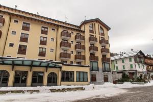 a large yellow building with balconies on it at Monolocale in centro a Madesimo in Madesimo