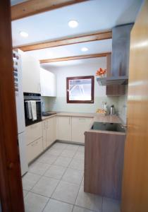 a kitchen with white cabinets and a sink at Grunthouse in Prebold