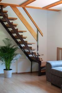 a staircase in a living room with a potted plant at Grunthouse in Prebold