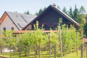 a house with a bunch of trees and a fence at Grunthouse in Prebold +8 photos