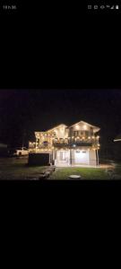 a house lit up at night with lights at L'toile Filante in Saint Zenon