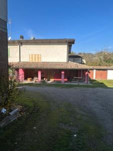 a large building with red doors in a yard at Da Lucio in Montecavolo