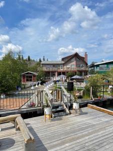 a wooden deck with chairs and a building at Aurora Bayside Inn in Yellowknife