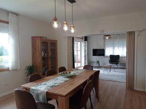 a dining room with a wooden table and chairs at Casa Playa Meira in Moaña