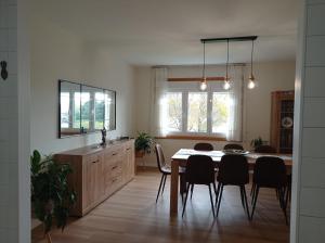 a kitchen and dining room with a table and chairs at Casa Playa Meira in Moaña +28 photos