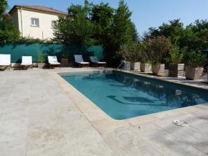 a swimming pool with lounge chairs and a house at Le Clos d'AIX studio 211 in Aix-en-Provence