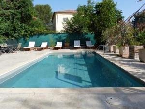 a large swimming pool with lounge chairs at Le Clos d'AIX studio 211 in Aix-en-Provence