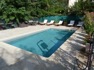 a swimming pool with some chairs and a table at Clos d'AIX studio 11 in Aix-en-Provence