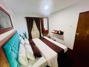 a hotel room with a bed with pillows at Ck home in Nuwara Eliya