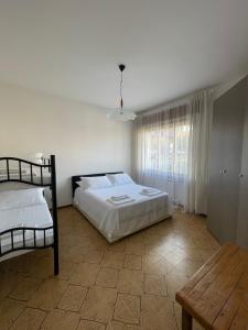 a bedroom with two bunk beds and a table at Casa Vacanze Ilenia in Marina di Montemarciano