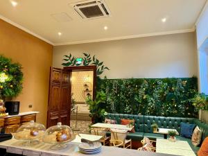 a restaurant with a green wall of plants at The Parr’s Bank Hotel in Warrington