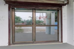 a window in a room with a view of a street at SPOT ON New Phulpur Restaurant And Hotel in Phūlpur