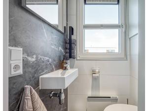 a bathroom with a sink and a toilet at Bright Base with Coastal Access in Ribnitz-Damgarten +30 photos