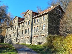 a large brick building on a road at Oben im Selketal Erste Etage in Harzgerode