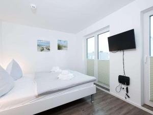 TV a/nebo společenská místnost v ubytování Holiday apartment in Olpenitz with sauna