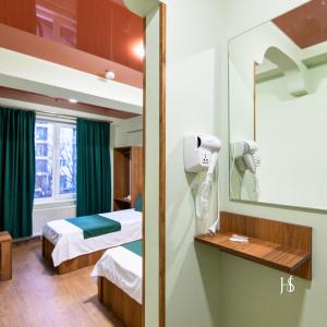 a hospital room with a bed and a mirror at Hotel Serenity in Tbilisi City +22 photos