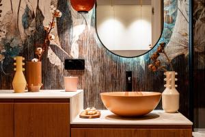 a bathroom with a bowl on a counter with a mirror at Scala Apartments by Blue Mandarin in Gdańsk +61 photos