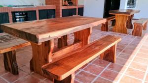 a wooden table and benches on a patio at Casa Angela María in Caacupé