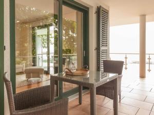 a table and chairs in a room with a glass door at Freya - with breathtaking sea views in Sassnitz