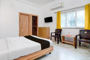 Ένα ή περισσότερα κρεβάτια σε δωμάτιο στο Hotel O Cosmopolis Bhubaneswar Formerly Luxury Stay