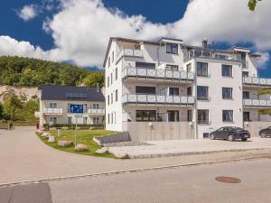 a white building with a car parked in front of it at One-bedroom apartment in Sassnitz