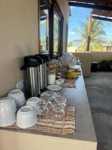 a long counter with food and drinks on it at Vila Dádiva Jeri in Jericoacoara +35 photos