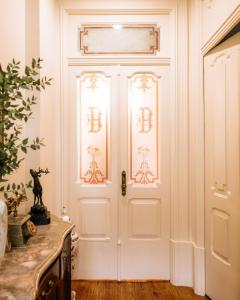 a white door with the letters b on it at Quinta das Luzes by Casa dos Sequeiras in Vila Nova de Gaia