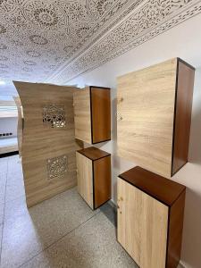 a room with two wooden cabinets and a ceiling at Soul Surf House in Agadir