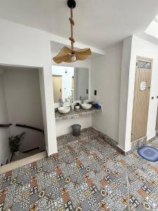 a bathroom with two sinks and a ceiling fan at Soul Surf House in Agadir