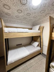 a couple of bunk beds in a room at Soul Surf House in Agadir +37 photos