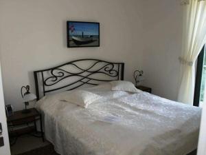 a bedroom with a white bed with a metal headboard at One-bedroom apartment in Sassnitz