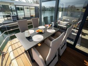 a dining table and chairs on a boat at Schönes Hausboot in Höxter in Höxter +17 photos