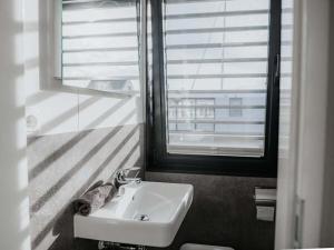 a bathroom with a sink and a window at Peenemünde Resort in Peenemünde