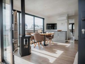 a living room with a fireplace and a table and chairs at Peenemünde Resort in Peenemünde