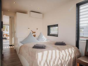 a bedroom with a large bed with two pillows on it at Peenemünde Resort in Peenemünde