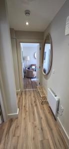 a hallway with wooden floors in a room at Turtle Cove in Portrush