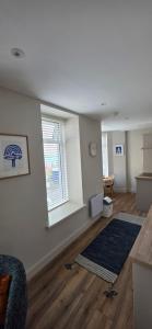 an empty living room with a couch and a window at Turtle Cove in Portrush