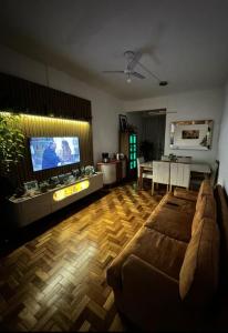 a living room with a couch and a flat screen tv at Copacabana - RJ Apto da Gaúcha in Rio de Janeiro