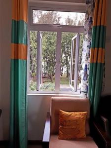 a window in a living room with a couch in front at Beachfront apartment-perfect sea escape! in Flic-en-Flac