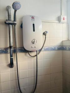 a shower in a bathroom with a white tank at Beachfront apartment-perfect sea escape! in Flic-en-Flac