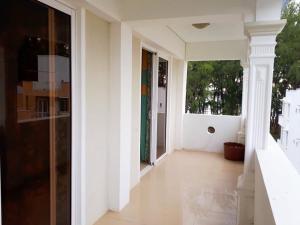 an empty hallway of a house with white walls at Beachfront apartment-perfect sea escape! in Flic-en-Flac