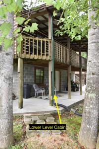 a deck on a house with a table and a chair at Laurel Lake Cabins in Corbin