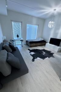 a living room with a couch and a bed at Scandic Nest in Jyväskylä
