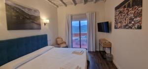 a bedroom with a bed and a window with a view at Hotel Rural Atalaya in Guadalupe