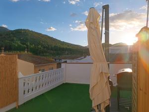 a balcony with green flooring on a house at Casa Caldereta in Ayelo de Rugat