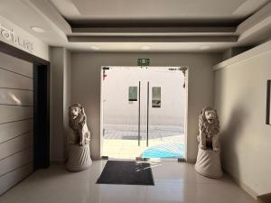 a room with a door with a statue in front of it at Hotel Nieto Express in Matamoros