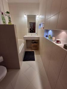 a bathroom with a tub and a sink and a toilet at Central Modern Studio - wifi, coffee in Bratislava