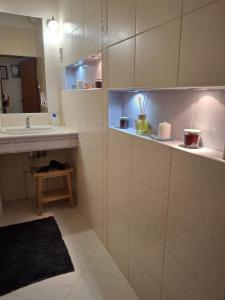 a bathroom with a sink and a mirror at Central Modern Studio - wifi, coffee in Bratislava