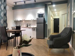 a kitchen with a table and chairs and a refrigerator at central square in Kutaisi