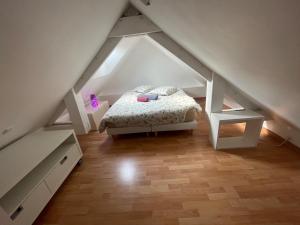 a bedroom with a bed in the attic at Les Dunes de Longchamp in Saint-Lunaire